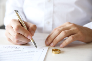 Man signing marriage contract, closeup